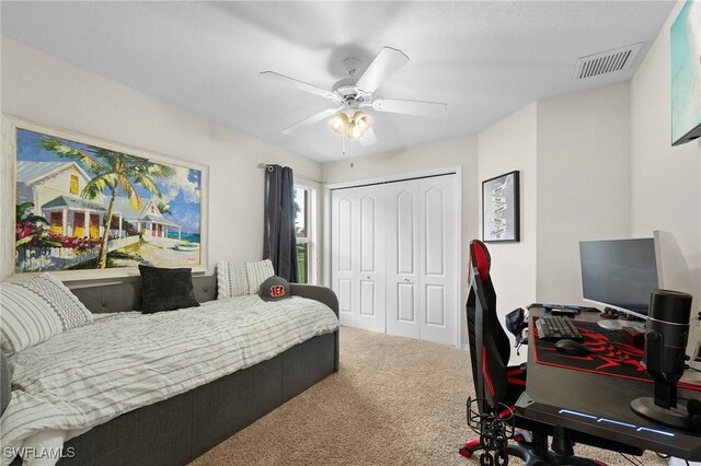 carpeted bedroom with a closet and ceiling fan