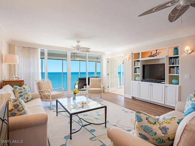 living room with light hardwood / wood-style floors, floor to ceiling windows, and crown molding