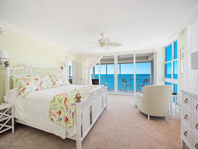 bedroom featuring ornamental molding, access to outside, ceiling fan, a water view, and a wall of windows