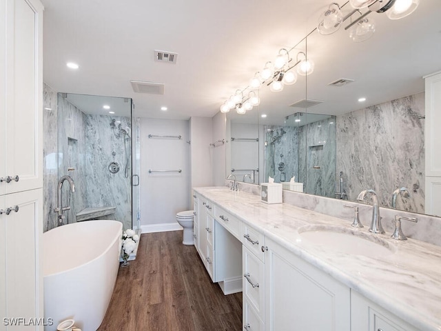 full bathroom with hardwood / wood-style flooring, vanity, toilet, and shower with separate bathtub