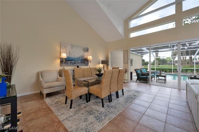 tiled dining area featuring high vaulted ceiling