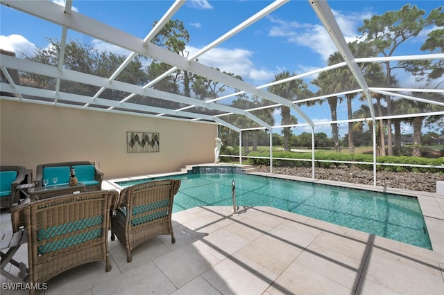 view of pool with a patio and glass enclosure