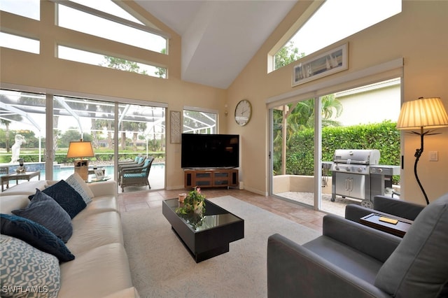 living room featuring light tile patterned floors and high vaulted ceiling