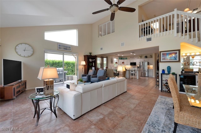 living room with ceiling fan and light tile patterned flooring