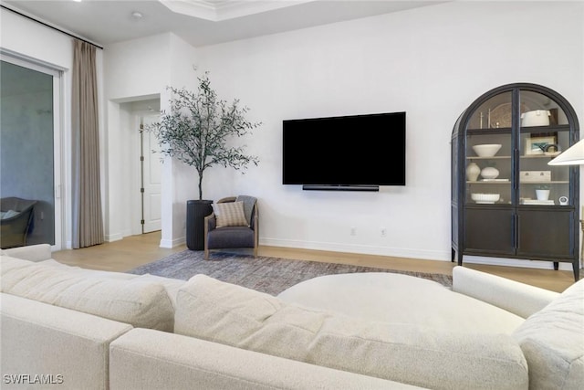 living room with hardwood / wood-style floors and ornamental molding