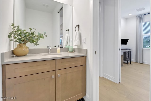 bathroom featuring vanity and hardwood / wood-style flooring