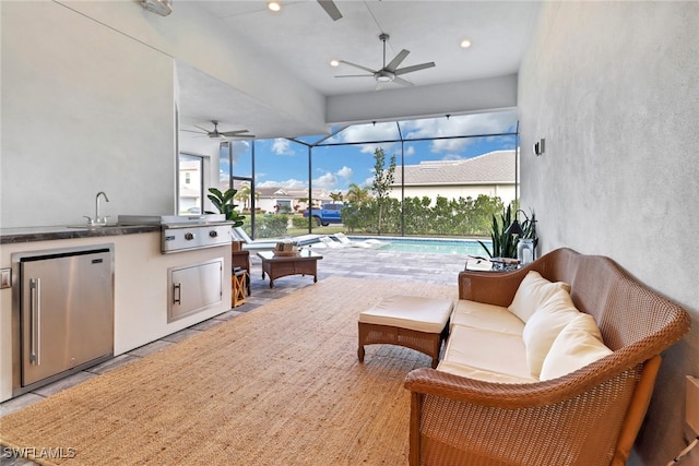 view of patio with glass enclosure, sink, an outdoor living space, grilling area, and area for grilling