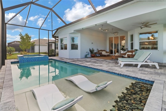 view of swimming pool with an in ground hot tub, an outdoor hangout area, ceiling fan, glass enclosure, and a patio area