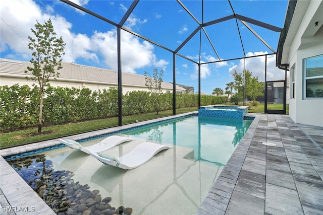 view of swimming pool with glass enclosure, an in ground hot tub, and a patio