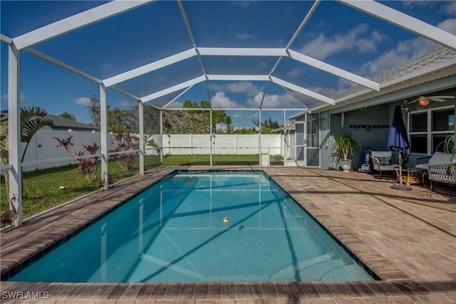 view of swimming pool featuring glass enclosure and a patio area