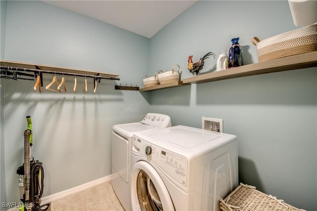 laundry area with light tile patterned floors and washer and clothes dryer