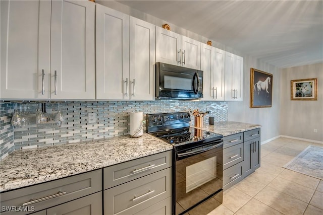 kitchen featuring light tile patterned floors, white cabinetry, gray cabinetry, and black appliances