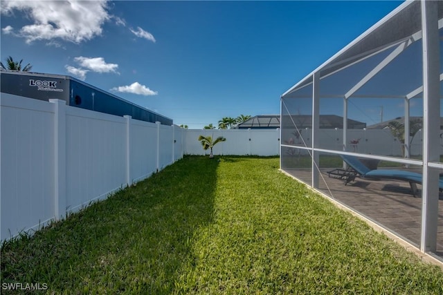 view of yard with a patio and a lanai