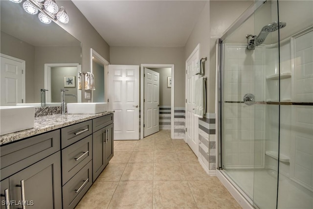 bathroom with tile patterned flooring, vanity, and an enclosed shower