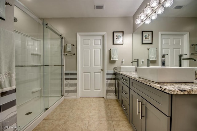 bathroom with tile patterned floors, vanity, and walk in shower