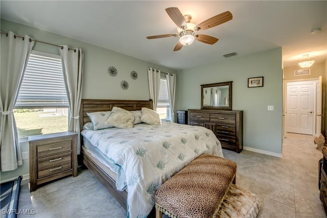 bedroom with multiple windows and ceiling fan