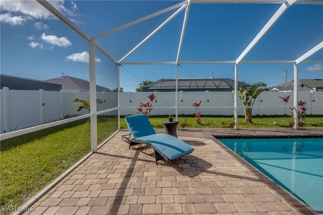 view of swimming pool with a lanai, a patio area, and a lawn