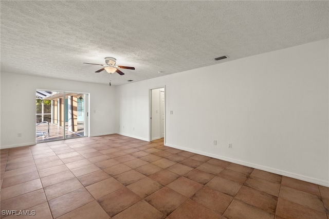 spare room with tile patterned flooring, a textured ceiling, and ceiling fan