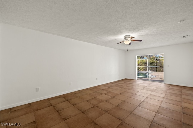 tiled empty room featuring ceiling fan