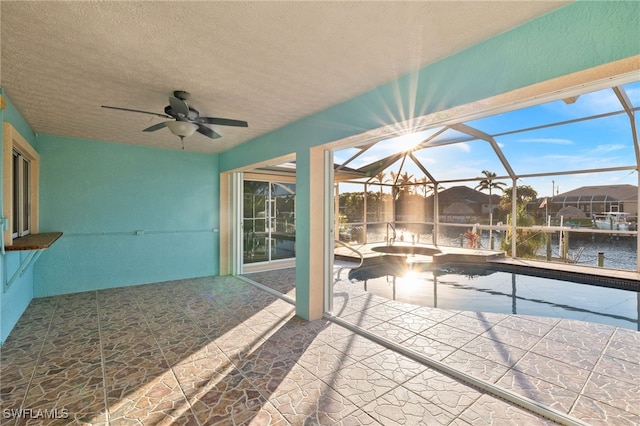 interior space with a water view, ceiling fan, and a lanai