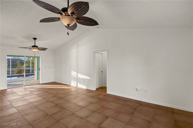 empty room with tile patterned flooring, lofted ceiling, a textured ceiling, and ceiling fan