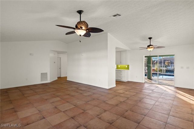 unfurnished living room featuring ceiling fan, lofted ceiling, and a textured ceiling