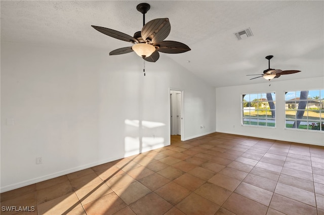 unfurnished room featuring lofted ceiling, visible vents, a textured ceiling, tile patterned flooring, and baseboards