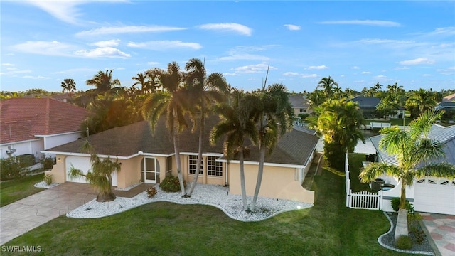 view of front of house featuring a garage and a front lawn