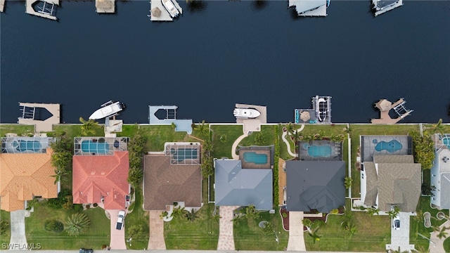 birds eye view of property featuring a water view and a residential view