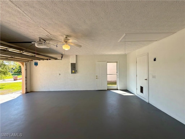 garage featuring electric panel and a garage door opener