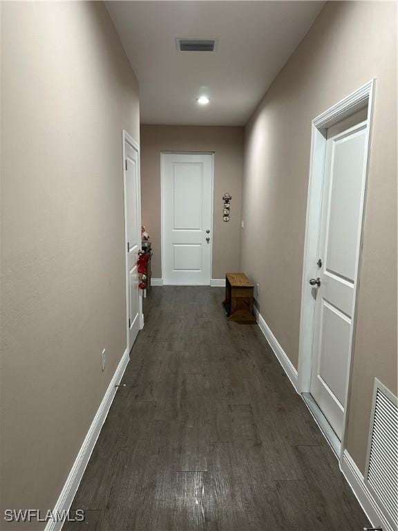 corridor with dark hardwood / wood-style floors