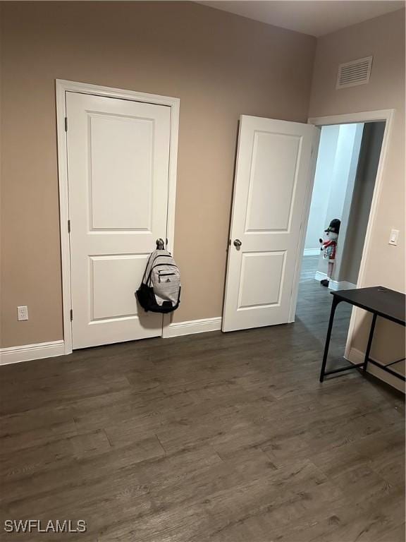 hall with dark hardwood / wood-style floors