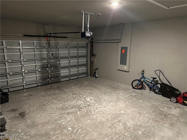 garage with electric panel and a garage door opener