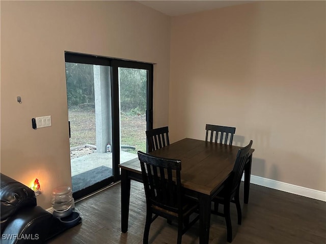 dining space with dark hardwood / wood-style flooring