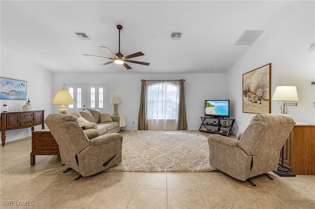 living room featuring ceiling fan, light tile patterned flooring, and lofted ceiling