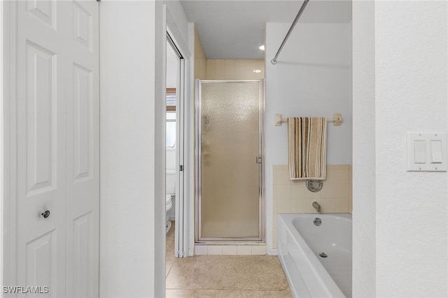 bathroom featuring tile patterned floors, separate shower and tub, and toilet