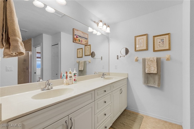 bathroom with tile patterned flooring and vanity