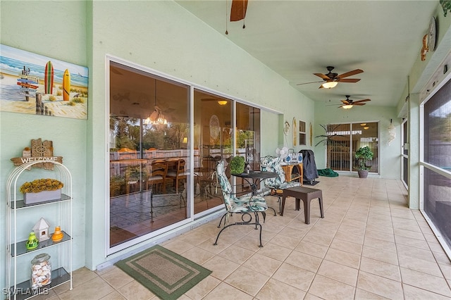 sunroom / solarium with ceiling fan and lofted ceiling