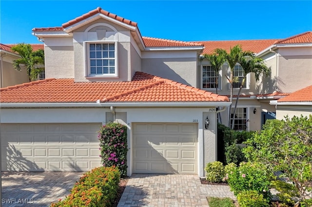 mediterranean / spanish house with a garage