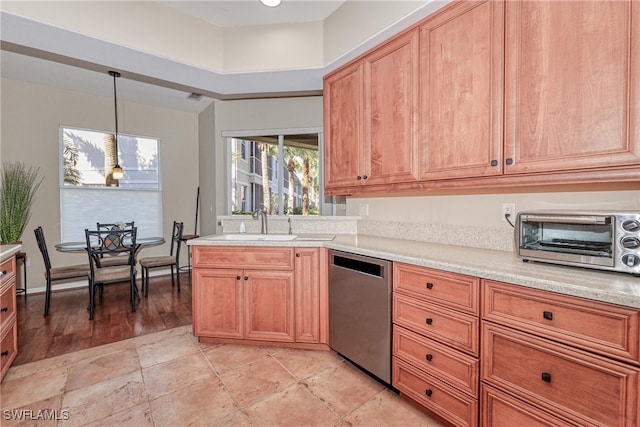 kitchen featuring stainless steel dishwasher, pendant lighting, and sink