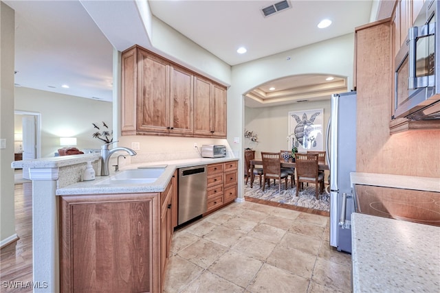 kitchen featuring kitchen peninsula, sink, and stainless steel appliances