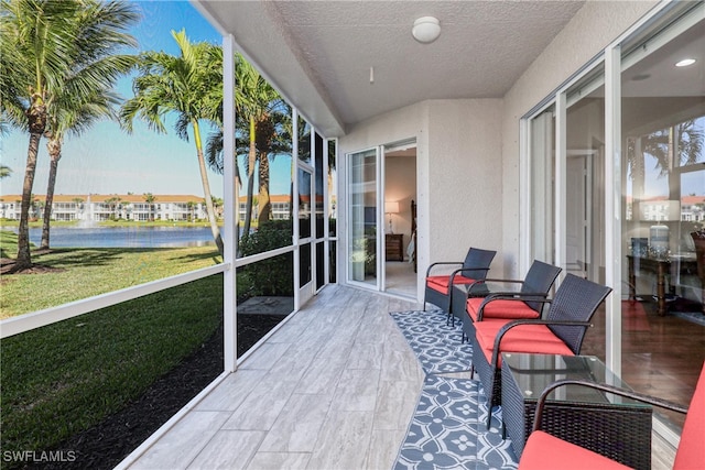 sunroom / solarium with a water view