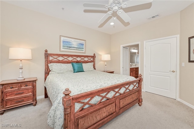 carpeted bedroom featuring ensuite bathroom and ceiling fan