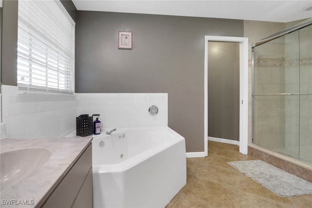 bathroom featuring vanity, tile patterned flooring, and plus walk in shower