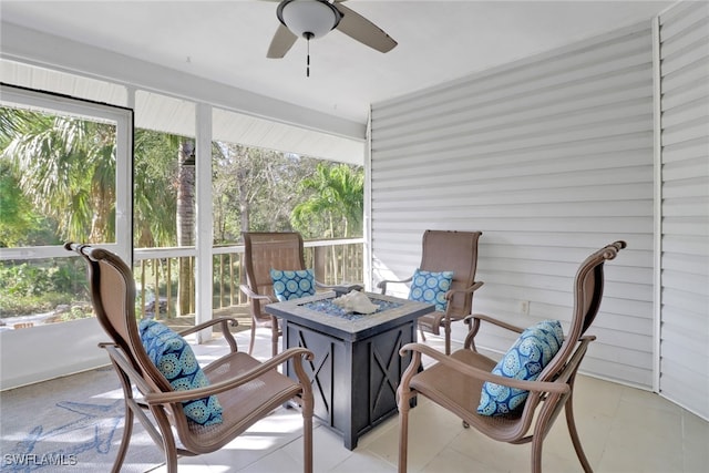 sunroom featuring ceiling fan