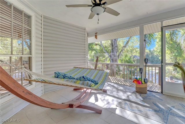 sunroom with plenty of natural light and ceiling fan