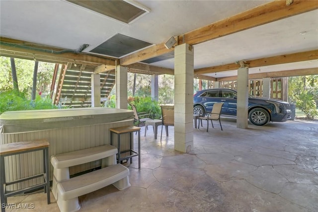 unfurnished sunroom featuring beamed ceiling and plenty of natural light