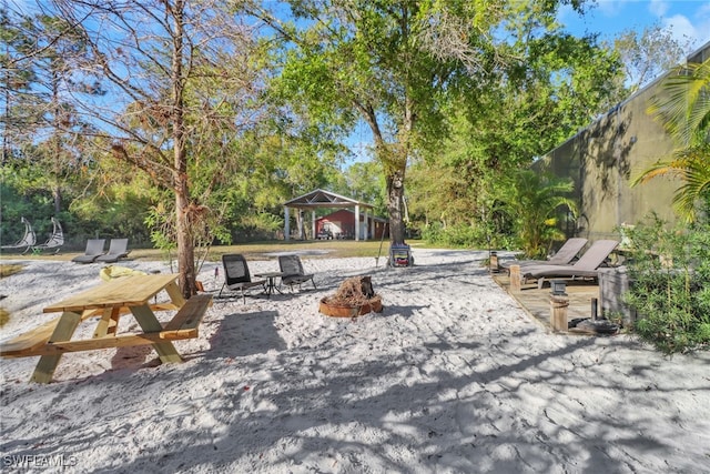 view of patio featuring a gazebo and an outdoor fire pit