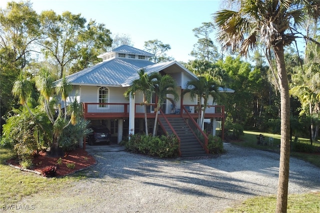 coastal inspired home with a carport and a porch