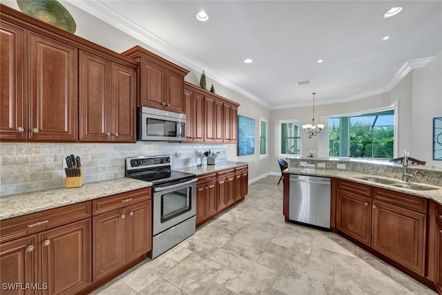 kitchen featuring decorative light fixtures, ornamental molding, a notable chandelier, and appliances with stainless steel finishes